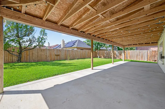 a view of a backyard with wooden fence