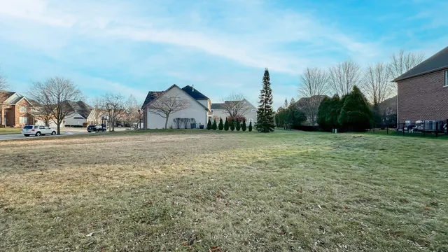 a view of a field with an house in background