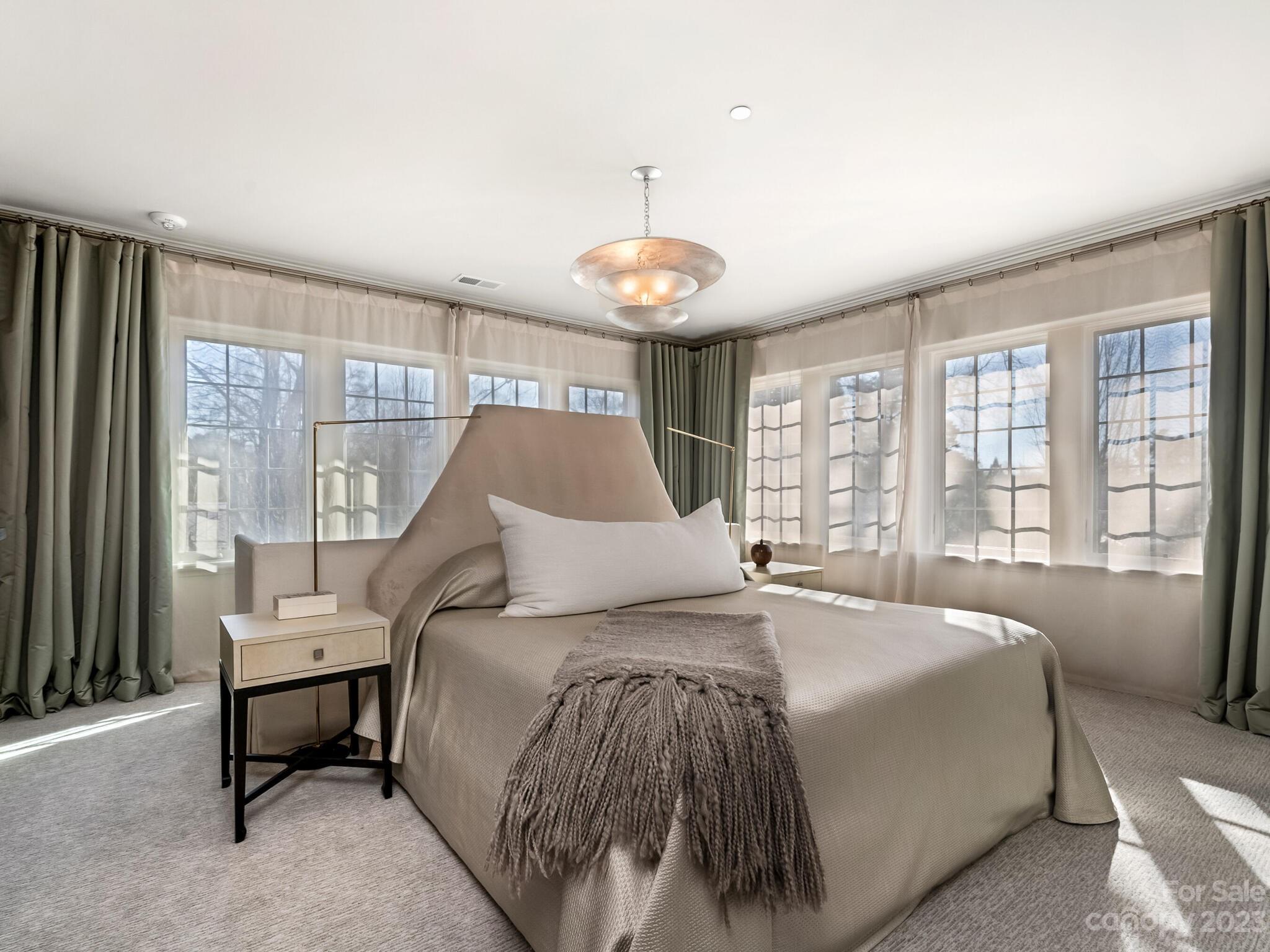 1200 Queens Road Charlotte, NC 28207 - Photo 21 of 42 a spacious bedroom with a bed and a large window