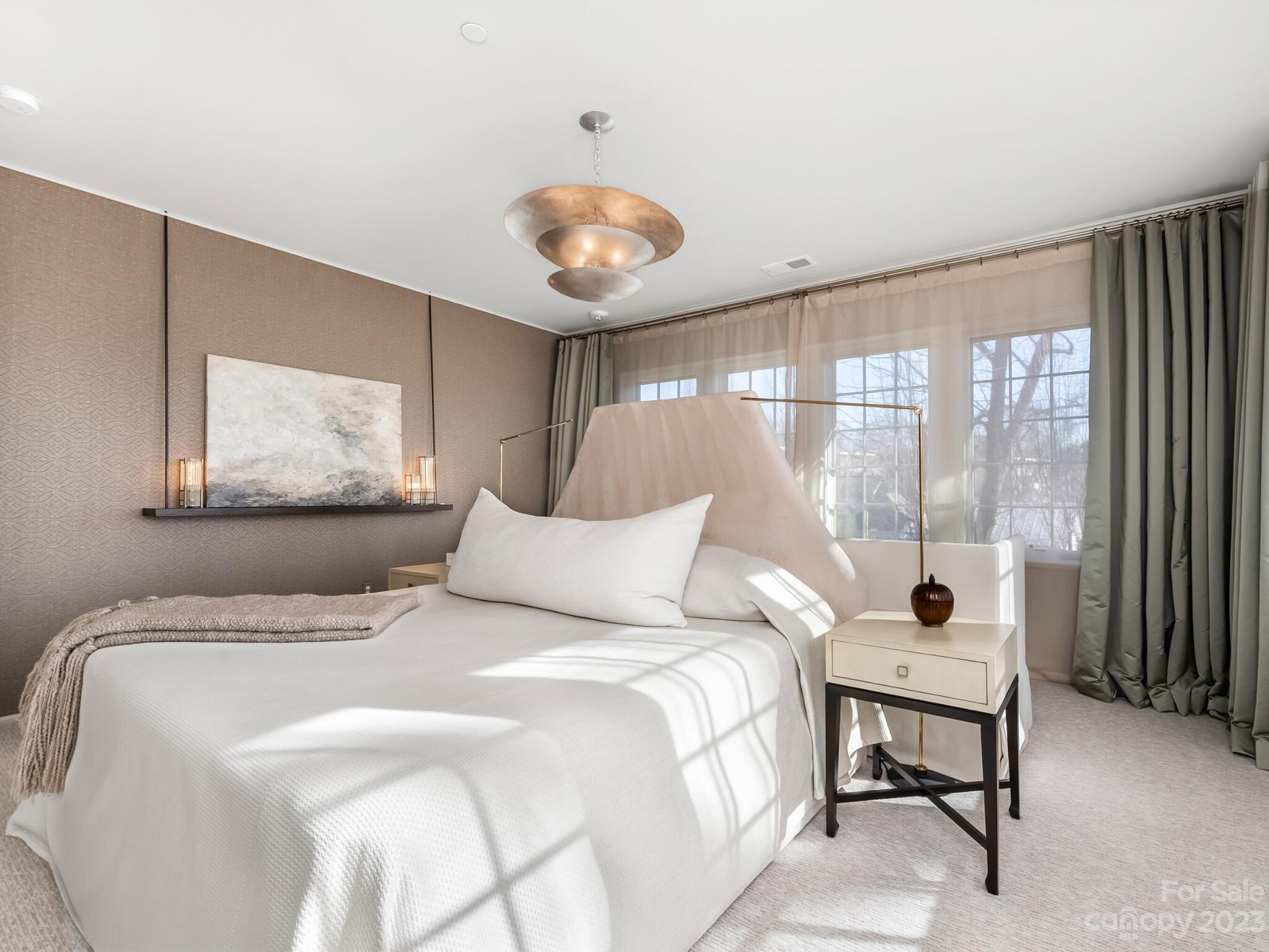 1200 Queens Road Charlotte, NC 28207 - Photo 22 of 42 a bedroom with a bed and a large window