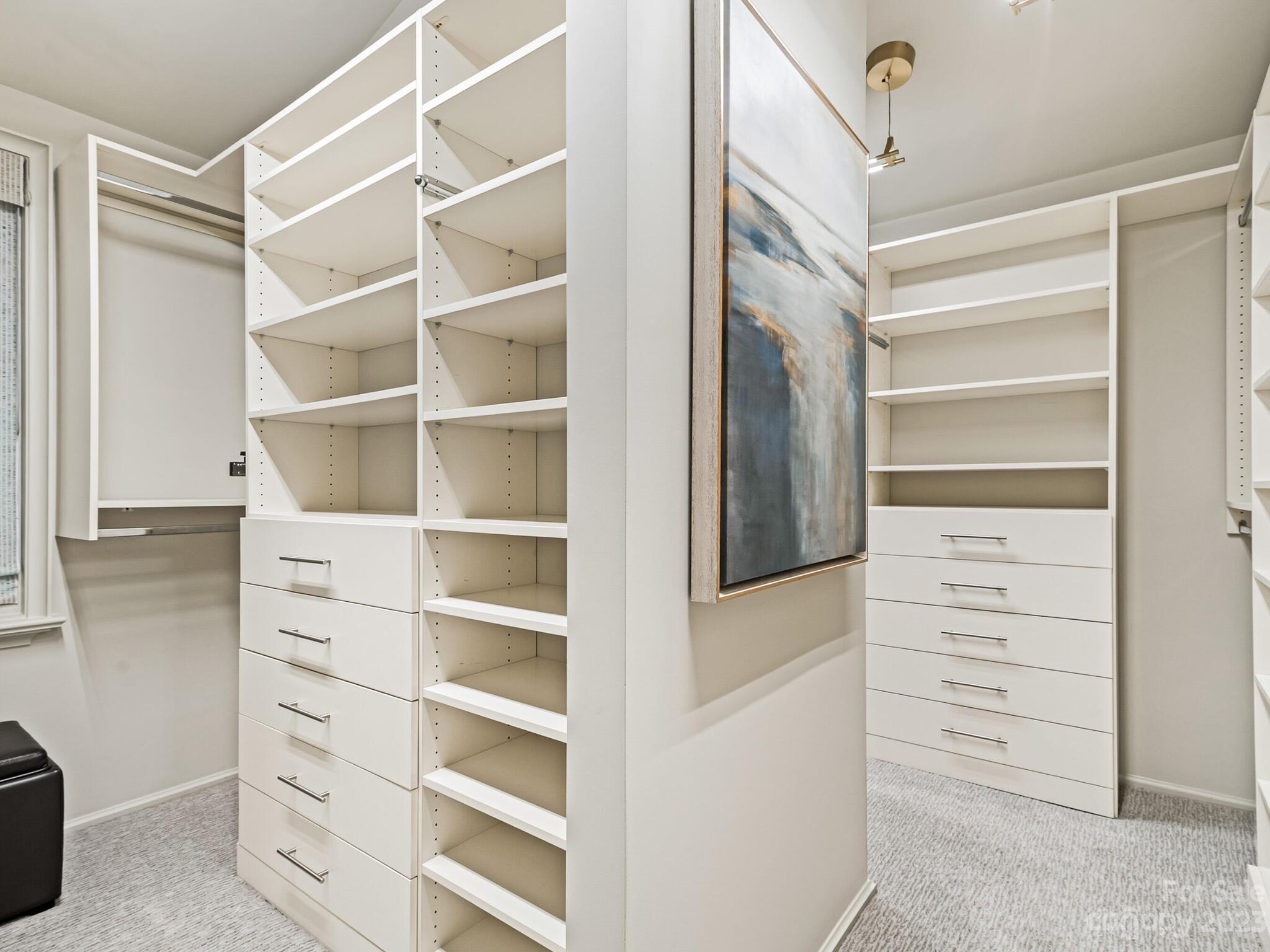 1200 Queens Road Charlotte, NC 28207 - Photo 25 of 42 a view of walk in closet with empty racks
