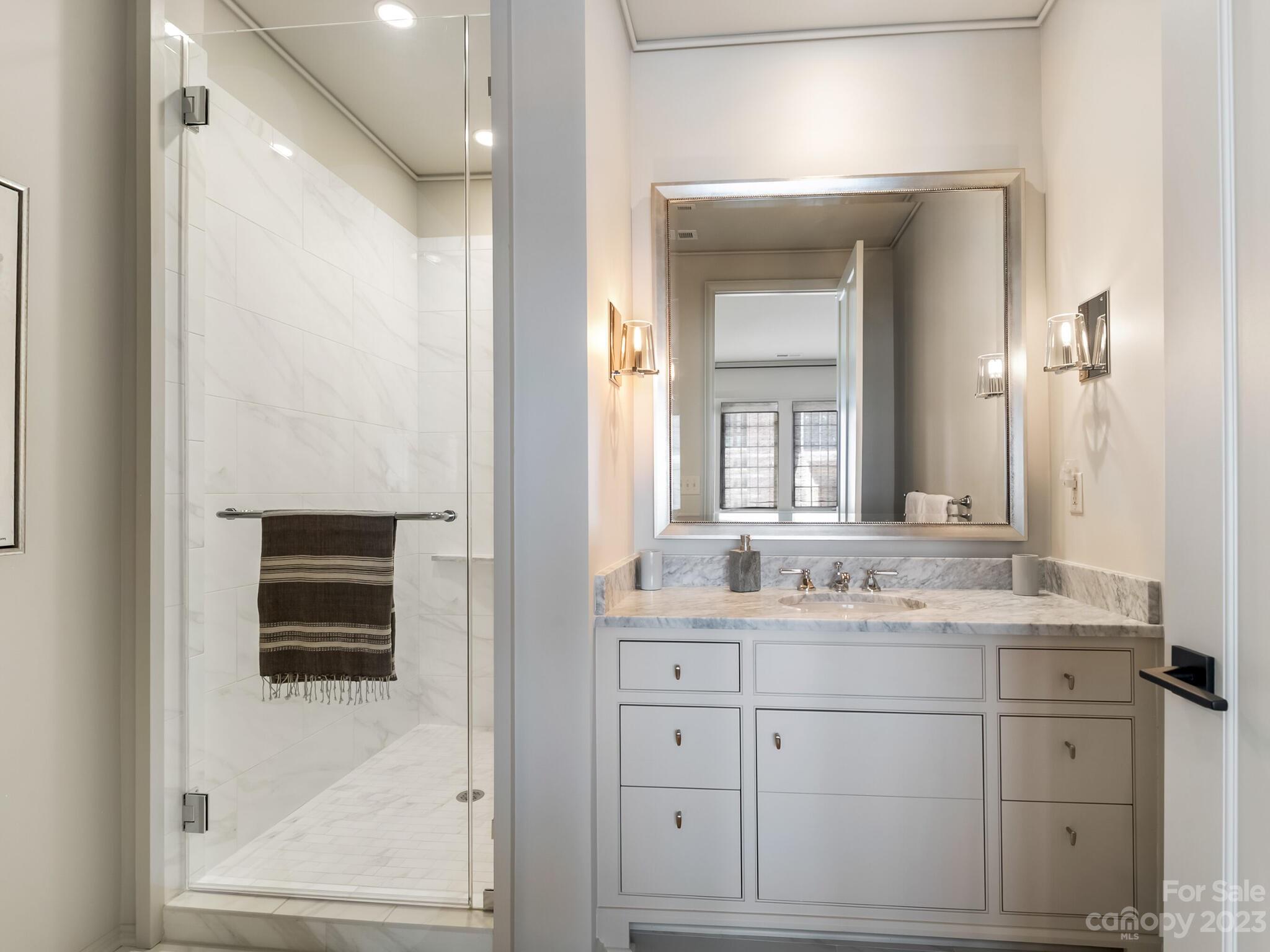 1200 Queens Road Charlotte, NC 28207 - Photo 27 of 42 a bathroom with a sink a vanity a mirror and a window