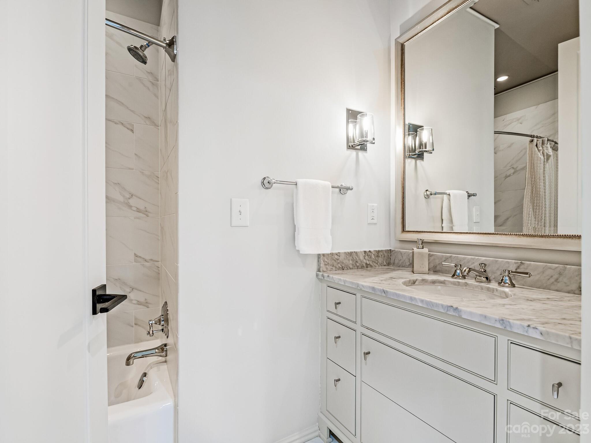 1200 Queens Road Charlotte, NC 28207 - Photo 30 of 42 a bathroom with a granite countertop sink and a mirror