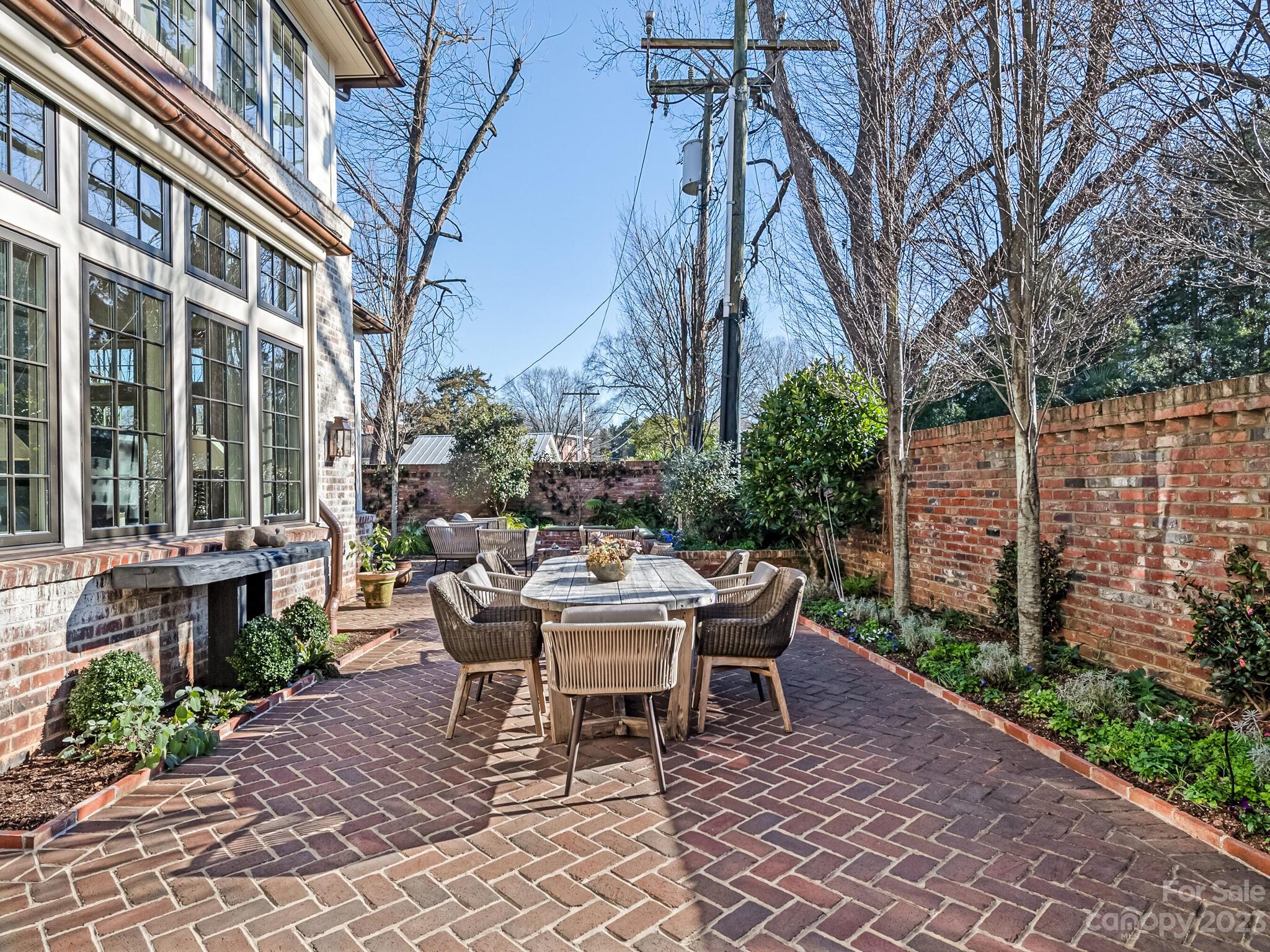 1200 Queens Road Charlotte, NC 28207 - Photo 34 of 42 a view of a patio with a table and chairs and potted plants