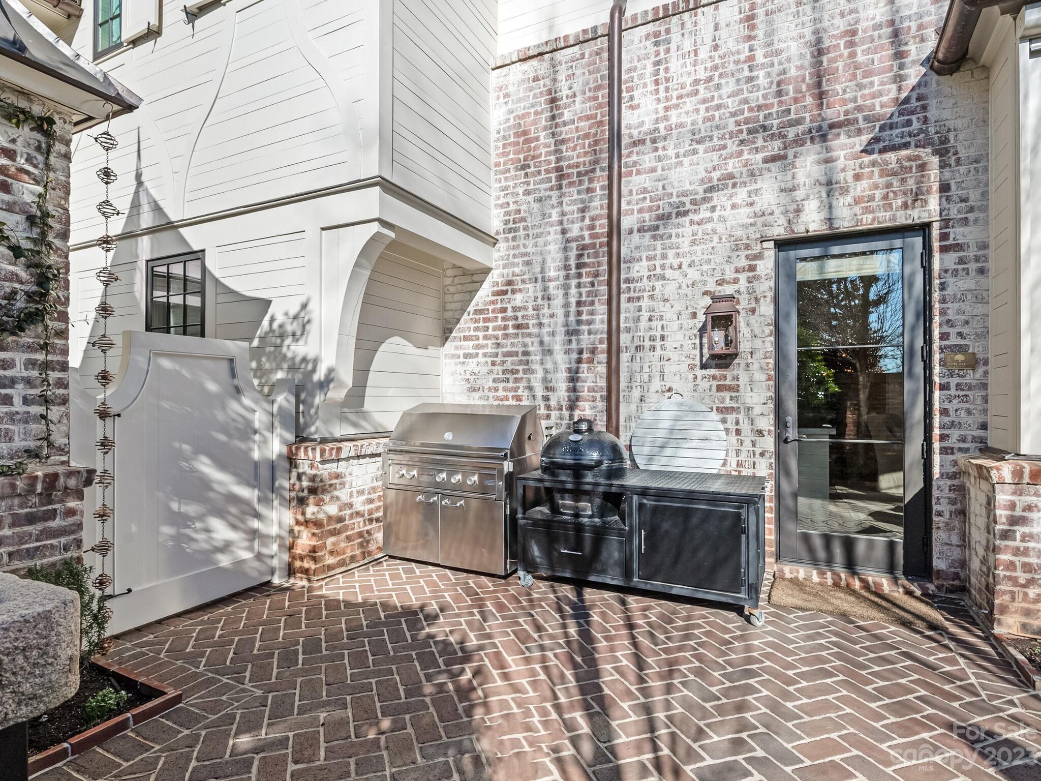 1200 Queens Road Charlotte, NC 28207 - Photo 36 of 42 a view of a patio with table and chairs and potted plants