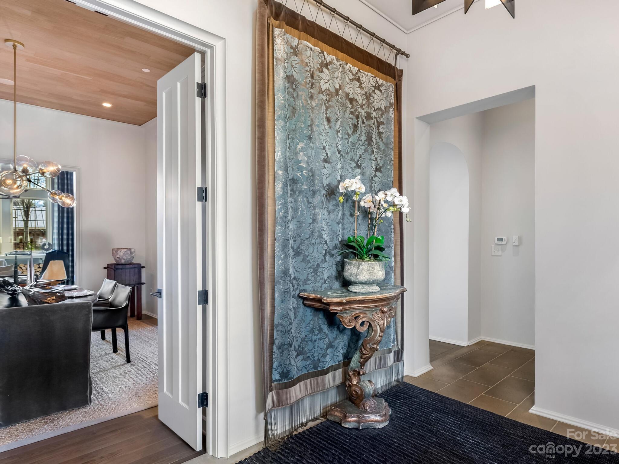 1200 Queens Road Charlotte, NC 28207 - Photo 5 of 42 a view of a hallway and dining room with wooden floor