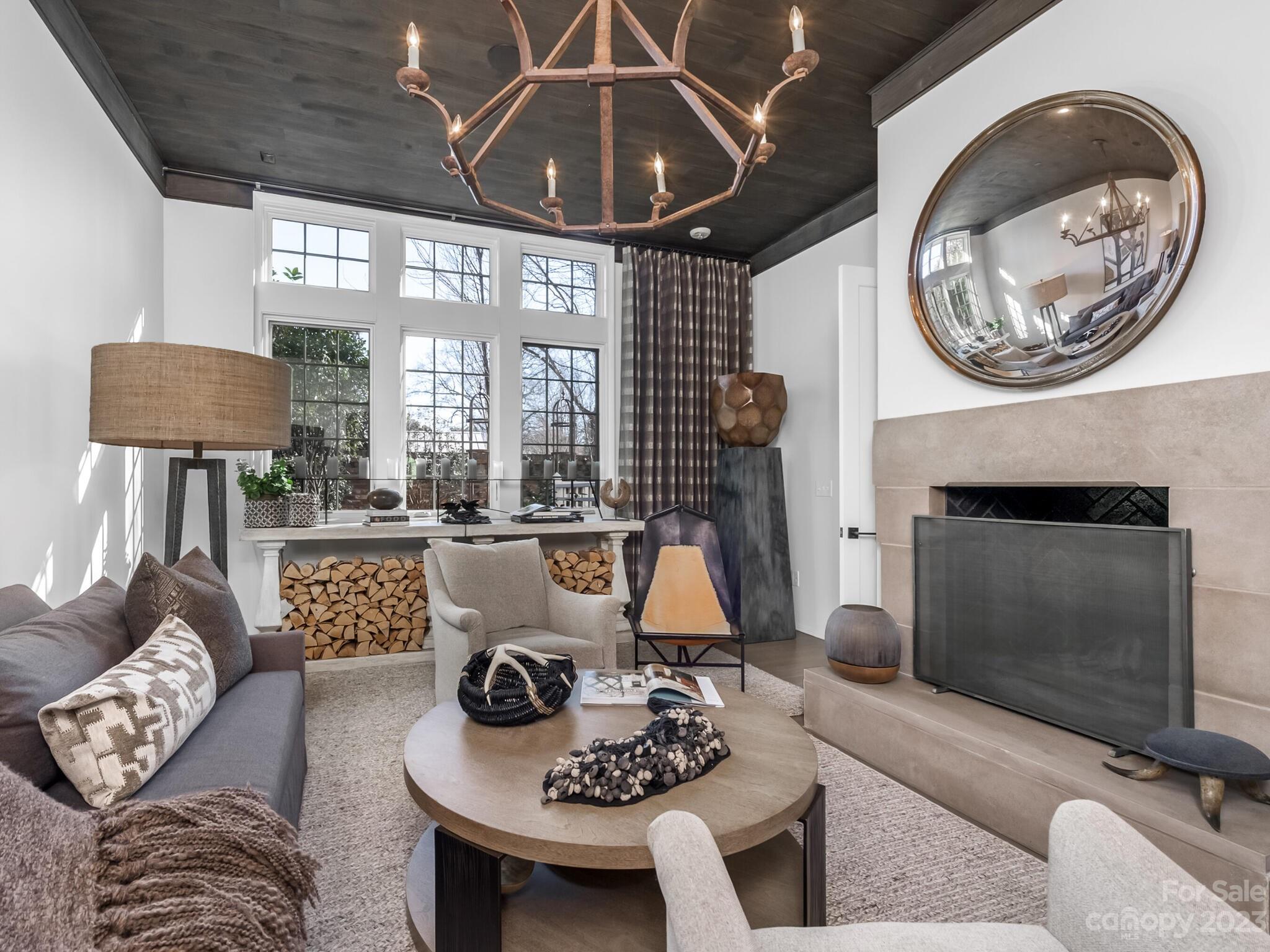 1200 Queens Road Charlotte, NC 28207 - Photo 8 of 42 a living room with furniture a fireplace and a chandelier