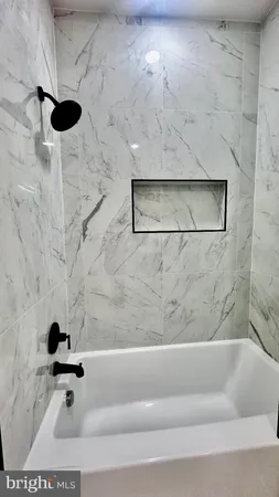 a bathroom with a granite countertop toilet a sink and shower