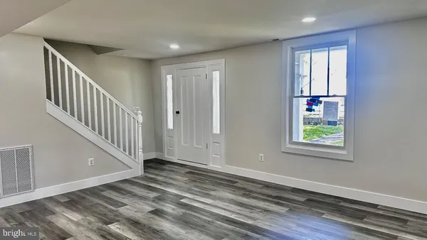 a view of an entryway with wooden floor