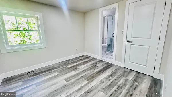 a bathroom with a granite countertop toilet and a shower