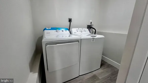 a view of a house with a yard and a large tree