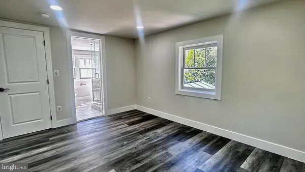 a kitchen with stainless steel appliances kitchen island granite countertop a stove and a refrigerator