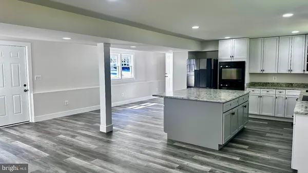 a kitchen with stainless steel appliances granite countertop a sink stove and cabinets