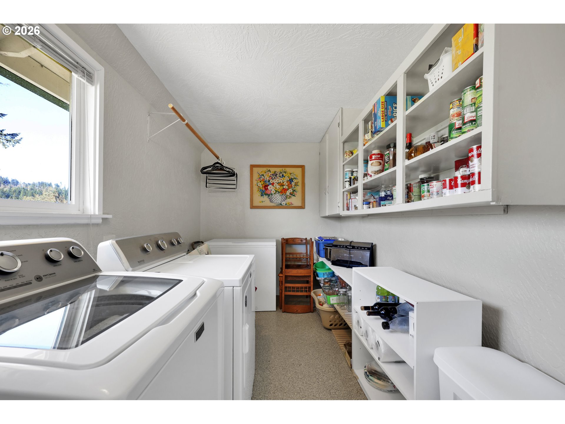 84816 Cloverdale Road Creswell, OR 97426 - Photo 19 of 48 a utility room with a refrigerator a sink and a painting on the wall