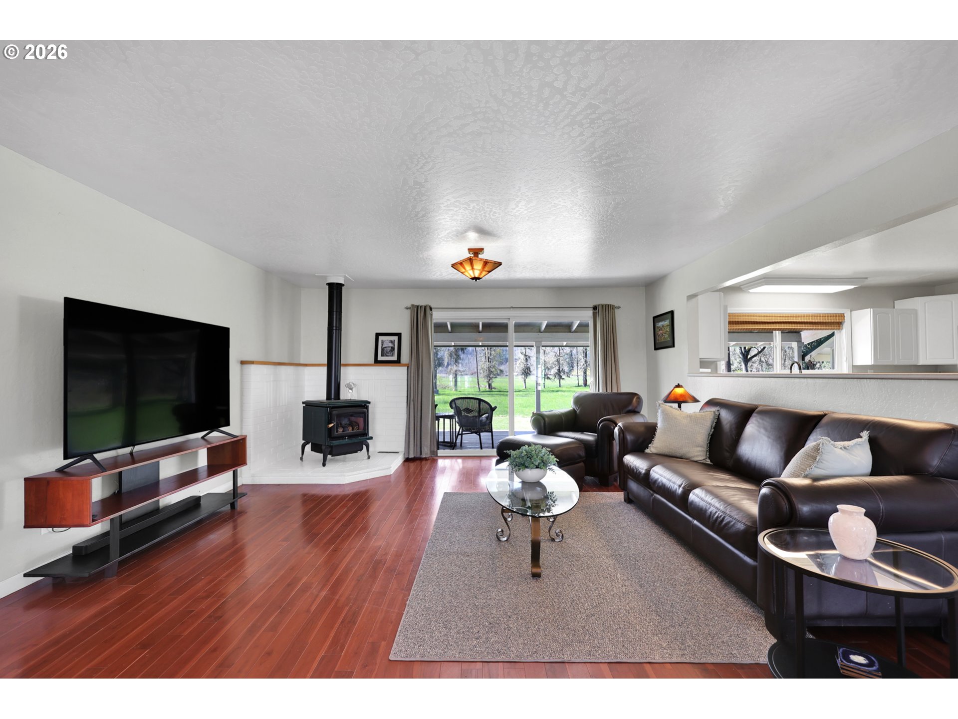 84816 Cloverdale Road Creswell, OR 97426 - Photo 8 of 48 a living room with fireplace furniture and a flat screen tv