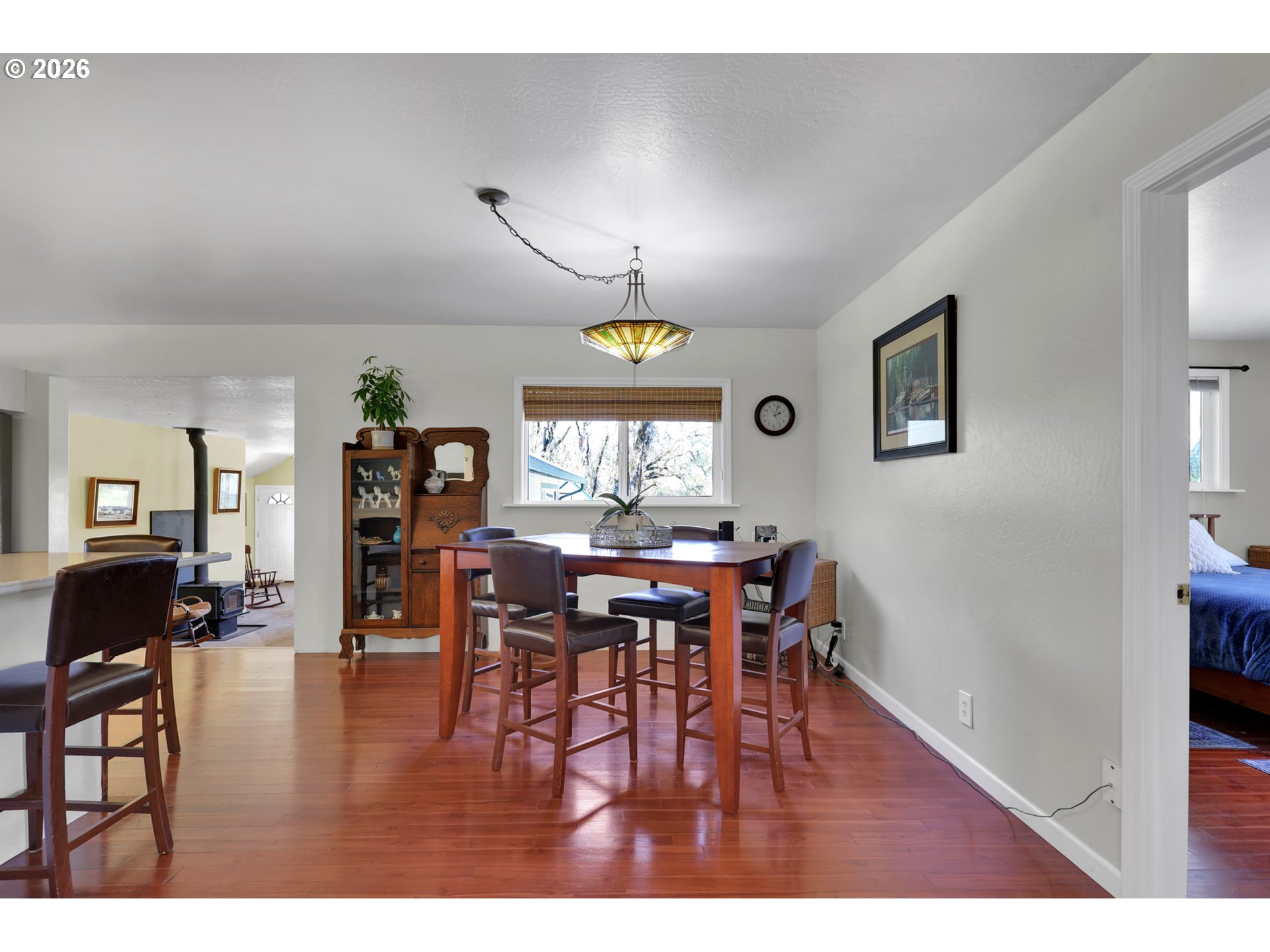 84816 Cloverdale Road Creswell, OR 97426 - Photo 10 of 48 a view of a dining room with furniture and wooden floor