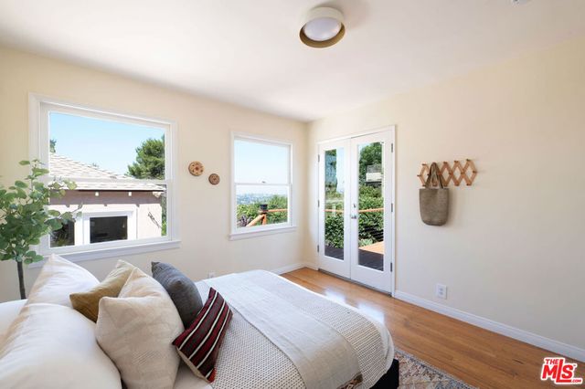 a bedroom with furniture and a window