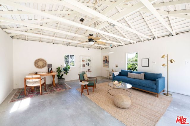 a living room with furniture and a clock