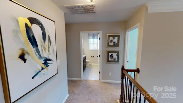 a view of a hallway with wooden floor and entryway