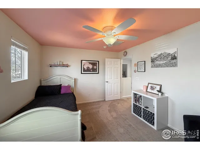 a living room with a bed furniture and a flat screen tv