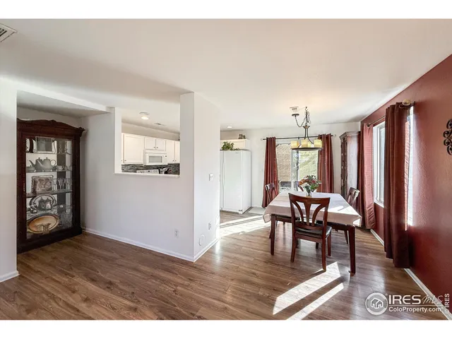 a dining room with furniture and wooden floor