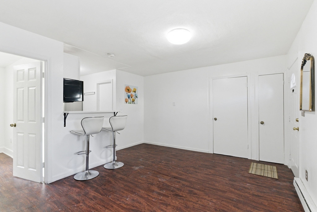 a view of empty room with wooden floor