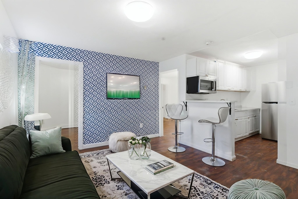 90 Brooks Street, Unit 90 Boston, MA 02128 - Photo 3 of 9 a living room with furniture and a rug