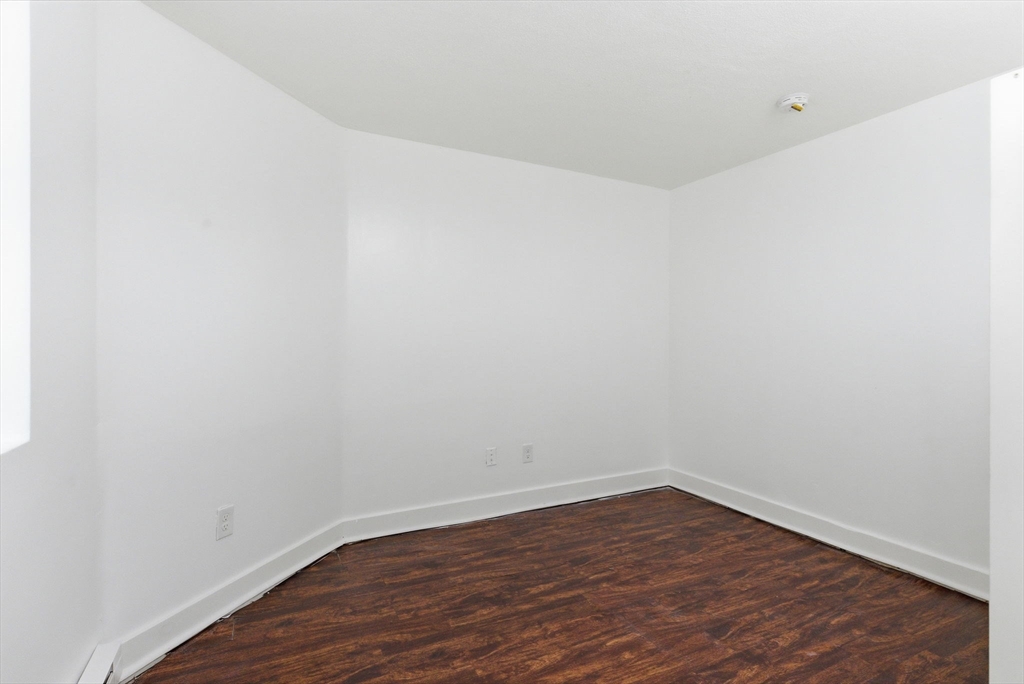 90 Brooks Street, Unit 90 Boston, MA 02128 - Photo 6 of 9 a view of an empty room with wooden floor