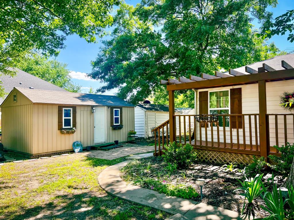 182 Douglas Street Van Alstyne, TX 75495 - Photo 4 of 23 Side deck and storage sheds