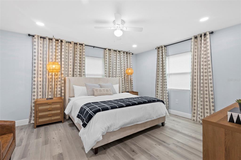 3708 North 56th Street Tampa, FL 33619 - Photo 13 of 22 a bedroom with a large bed and a chandelier