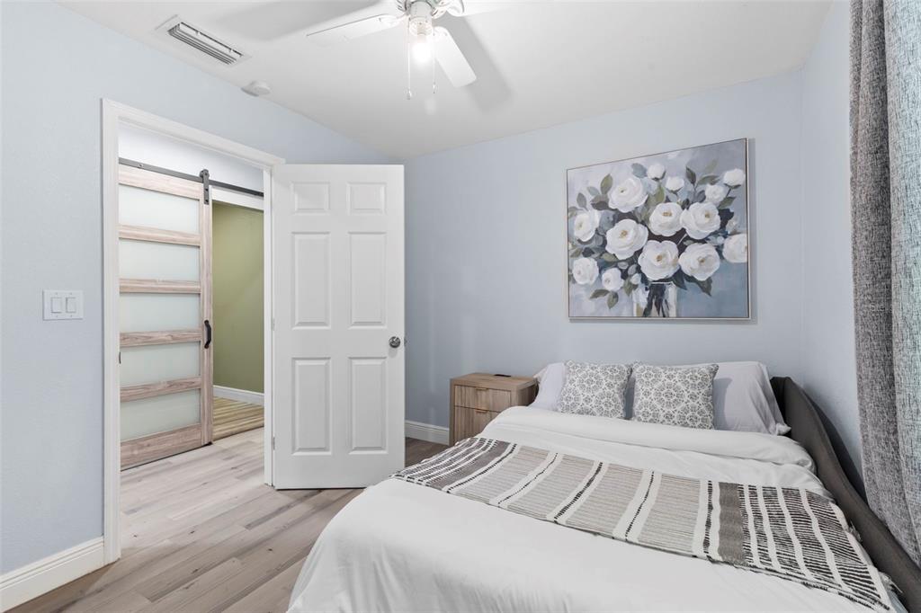 3708 North 56th Street Tampa, FL 33619 - Photo 19 of 22 a bedroom with a bed and a painting on the wall