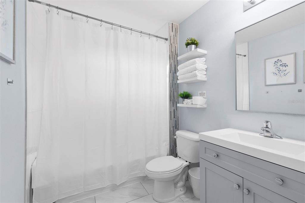 3708 North 56th Street Tampa, FL 33619 - Photo 20 of 22 a bathroom with a sink a toilet and a shower