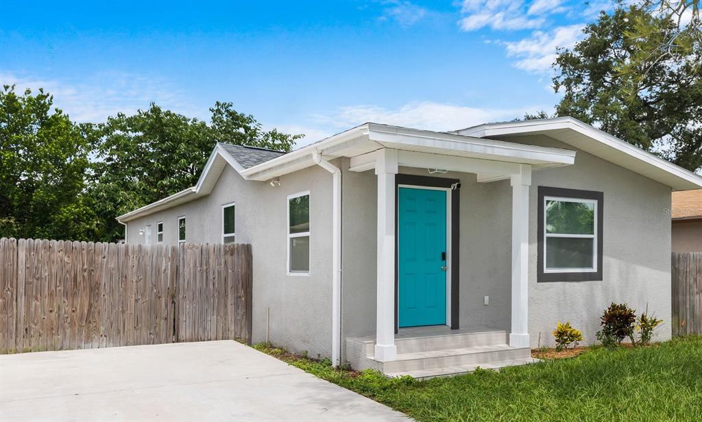 3708 North 56th Street Tampa, FL 33619 - Photo 2 of 22 a front view of a house with a garden