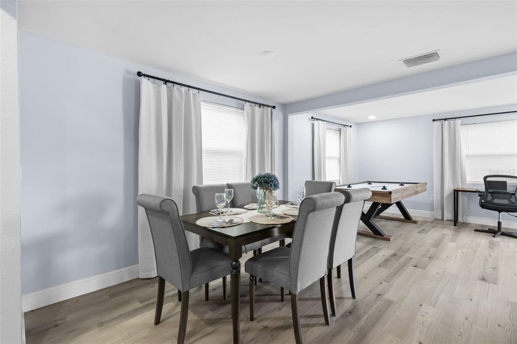 3708 North 56th Street Tampa, FL 33619 - Photo 9 of 22 a view of a dining room with furniture and wooden floor