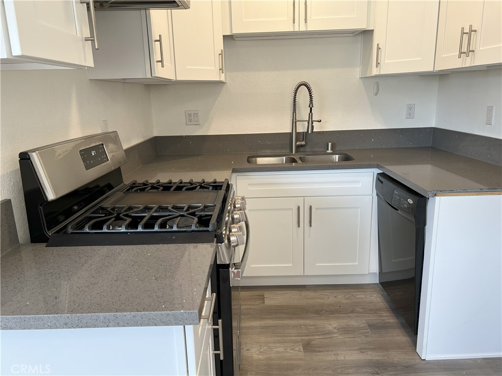 800 Grand Avenue, Unit C4 Diamond Bar, CA 91765 - Photo 4 of 19 a white kitchen with stainless steel appliances granite countertop white cabinets and a stove