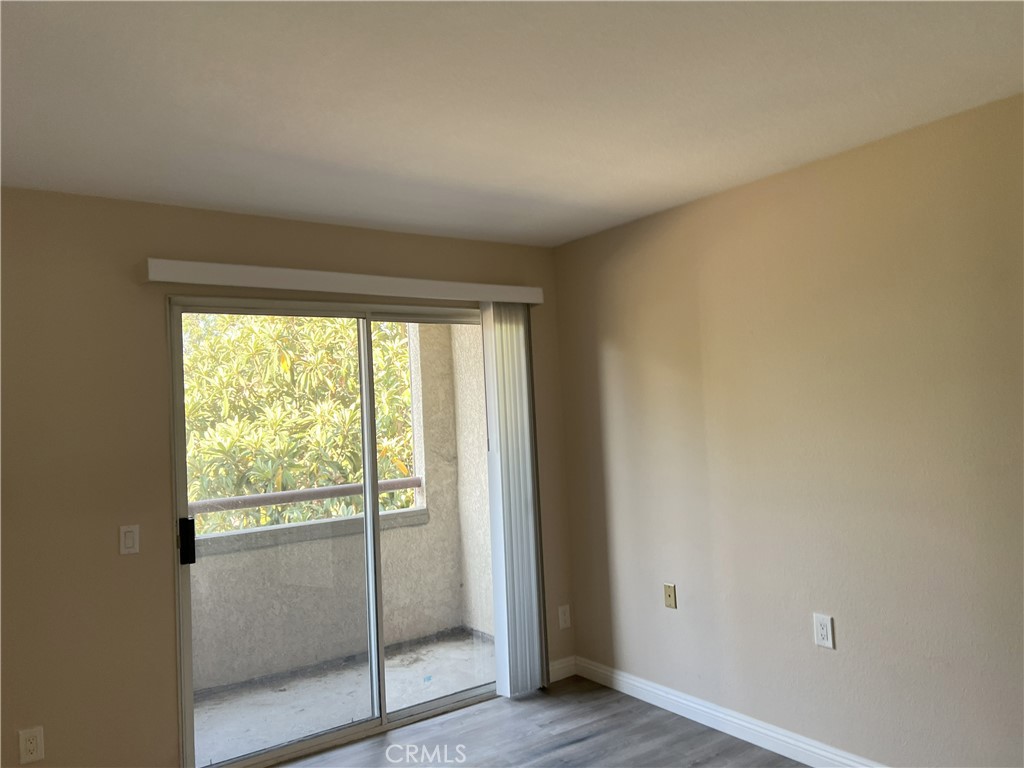 800 Grand Avenue, Unit C4 Diamond Bar, CA 91765 - Photo 8 of 19 a view of an empty room with wooden floor and a window