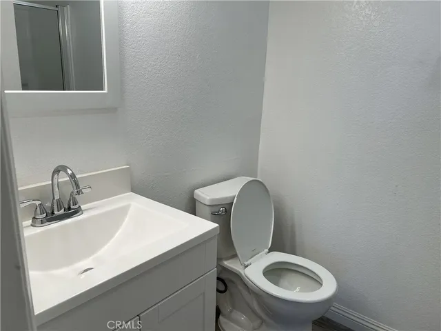a white toilet sitting next to a bathroom sink