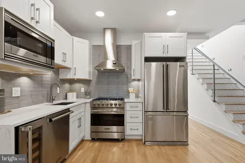 a kitchen with stainless steel appliances a refrigerator sink and microwave