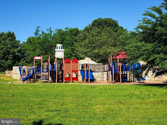 a view of a park that has lots of swings and slides