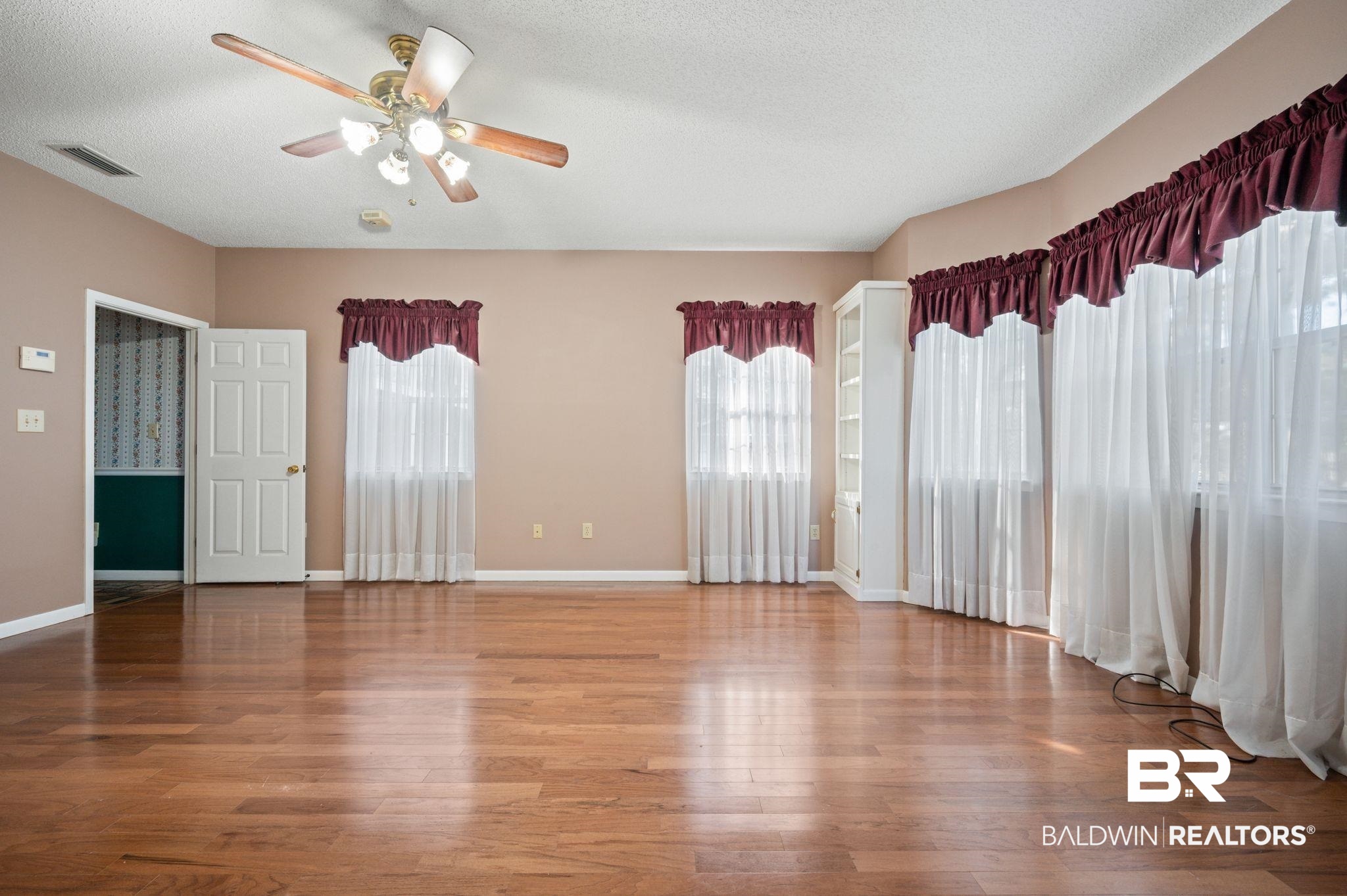 15801 Maytower Road Bay Minette, AL 36507 - Photo 12 of 43 Unfurnished room with hardwood / wood-style floors and a textured ceiling