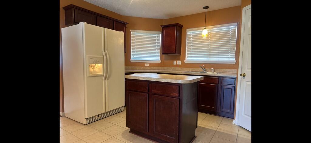 267 Limestone Circle Crestview, FL 32539 - Photo 11 of 21 a kitchen with a sink a refrigerator and cabinets