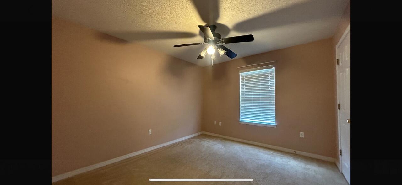 267 Limestone Circle Crestview, FL 32539 - Photo 20 of 21 a view of a hallway with a chandelier fan