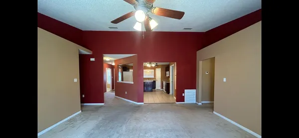 a view of a livingroom with a ceiling fan and window