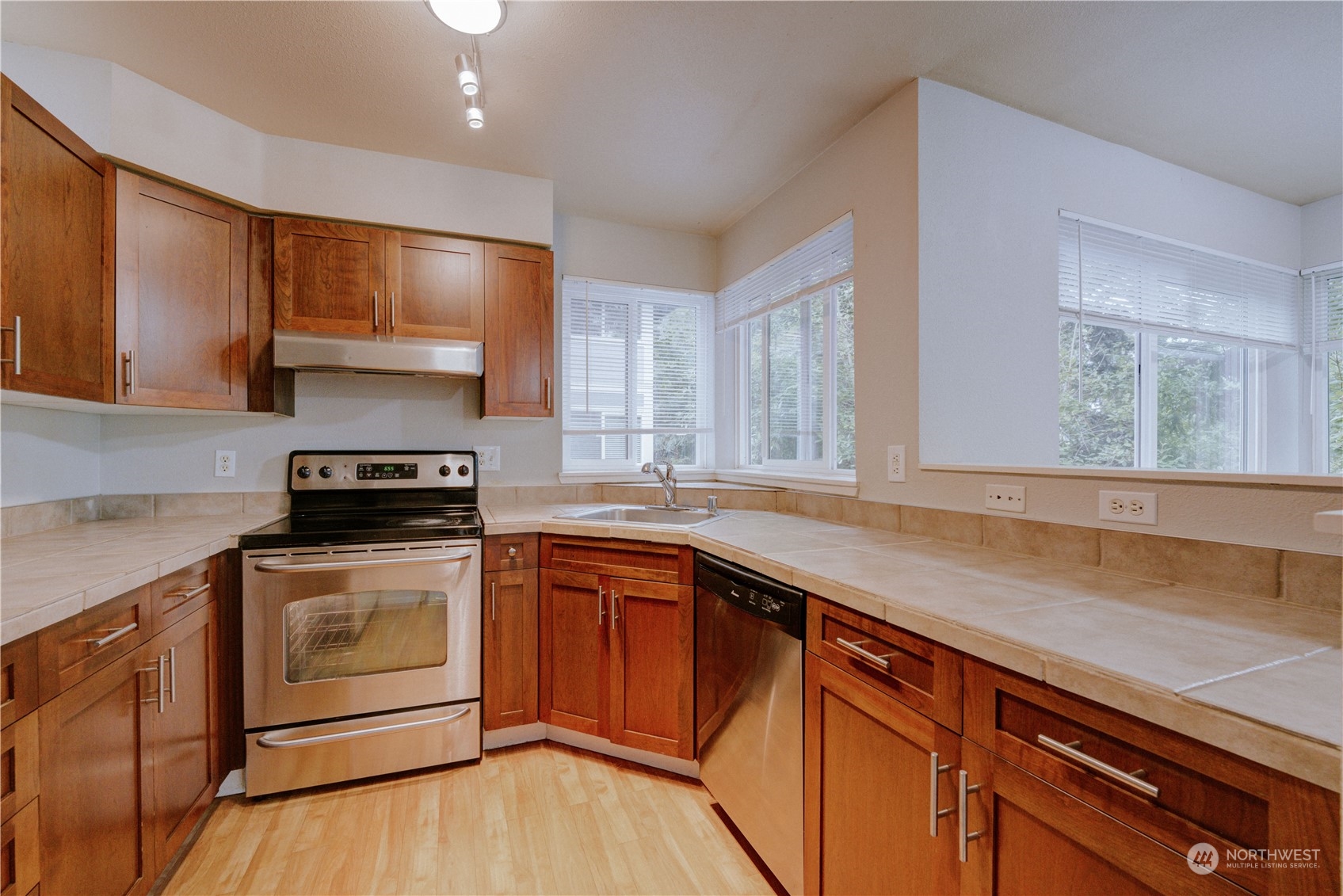 3908 243rd Place Southeast, Unit Q202 Bothell, WA 98021 - Photo 11 of 40 a kitchen with a sink stove and cabinets