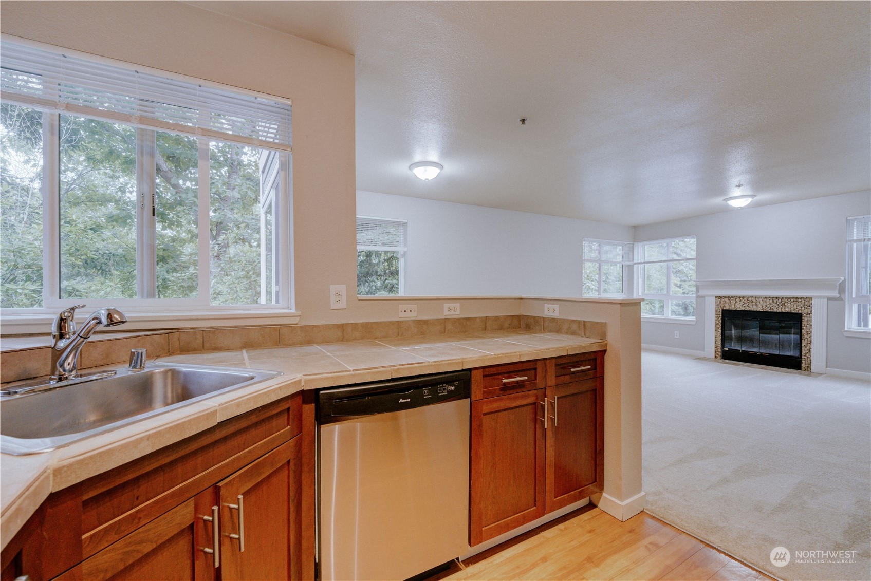 3908 243rd Place Southeast, Unit Q202 Bothell, WA 98021 - Photo 14 of 40 a kitchen with a sink and a large window