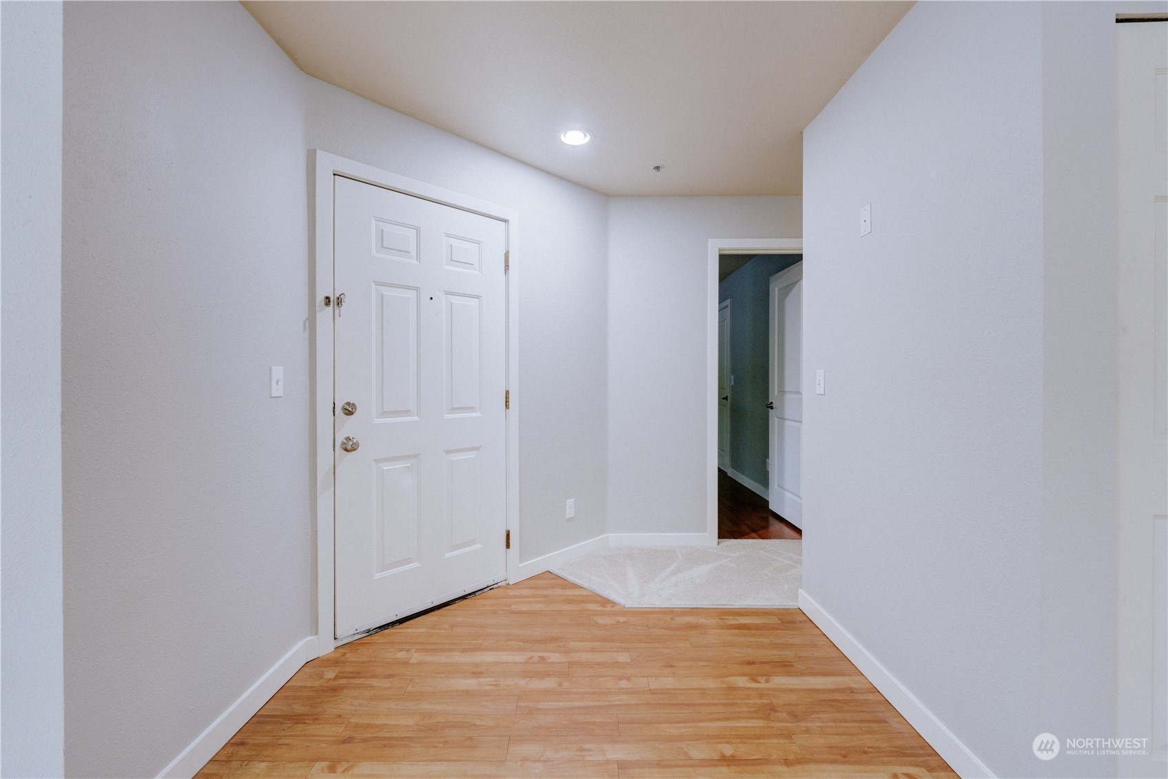 3908 243rd Place Southeast, Unit Q202 Bothell, WA 98021 - Photo 17 of 40 a view of a hallway with wooden floor and closet