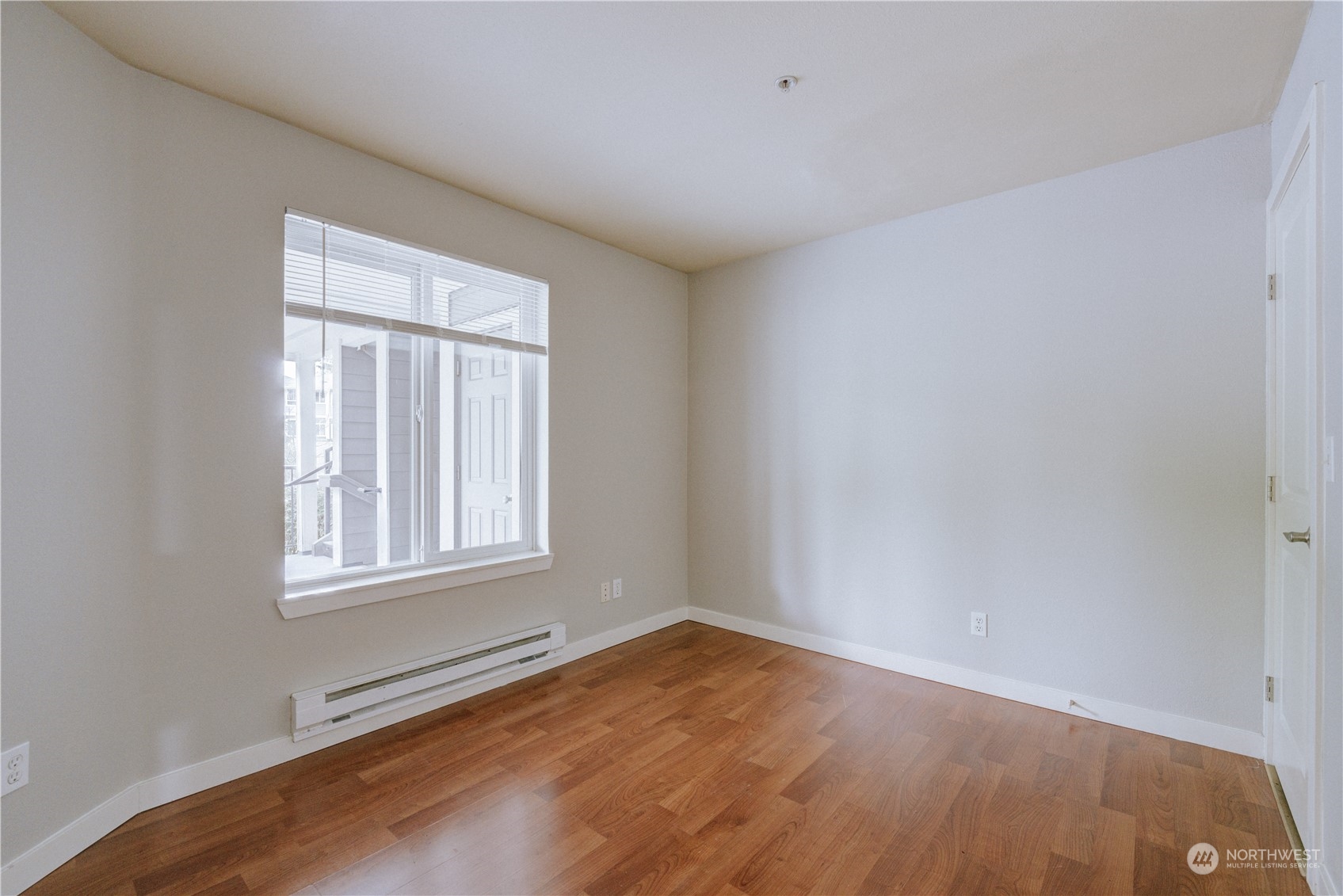 3908 243rd Place Southeast, Unit Q202 Bothell, WA 98021 - Photo 19 of 40 an empty room with wooden floor and windows