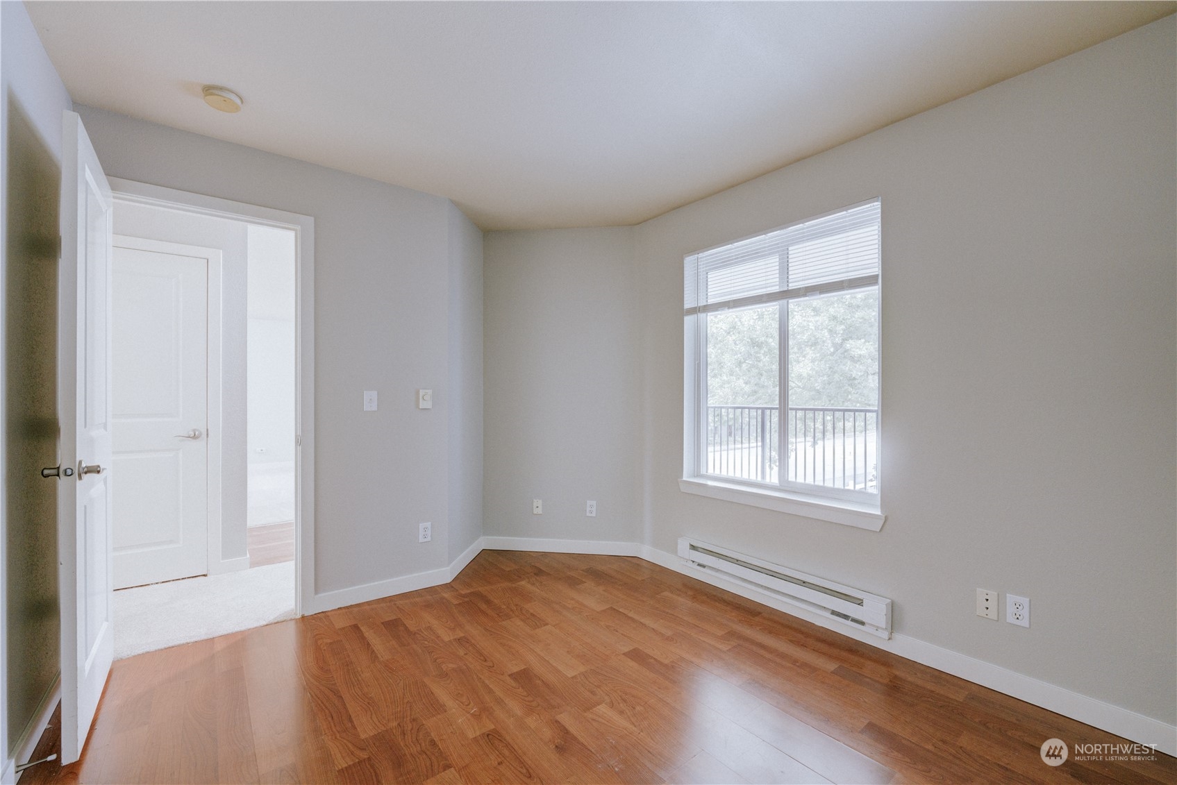 3908 243rd Place Southeast, Unit Q202 Bothell, WA 98021 - Photo 20 of 40 an empty room with wooden floor and windows