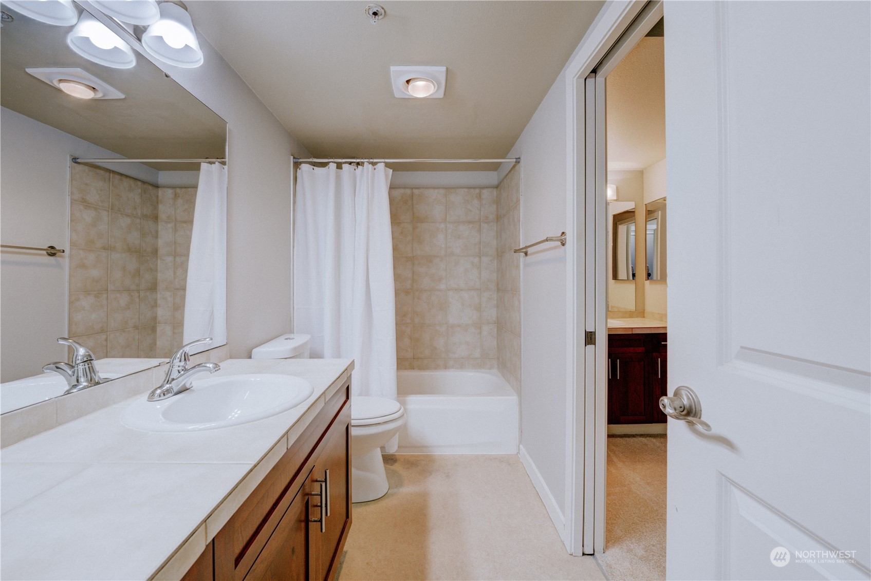 3908 243rd Place Southeast, Unit Q202 Bothell, WA 98021 - Photo 24 of 40 a bathroom with a sink a toilet and shower