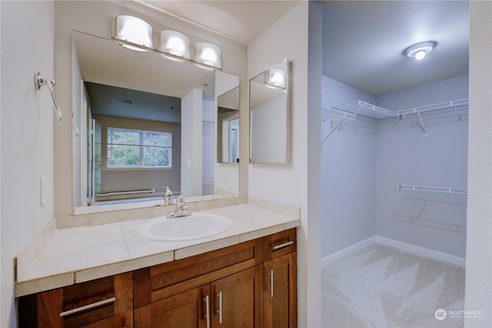 3908 243rd Place Southeast, Unit Q202 Bothell, WA 98021 - Photo 26 of 40 a bathroom with a sink a vanity and a mirror